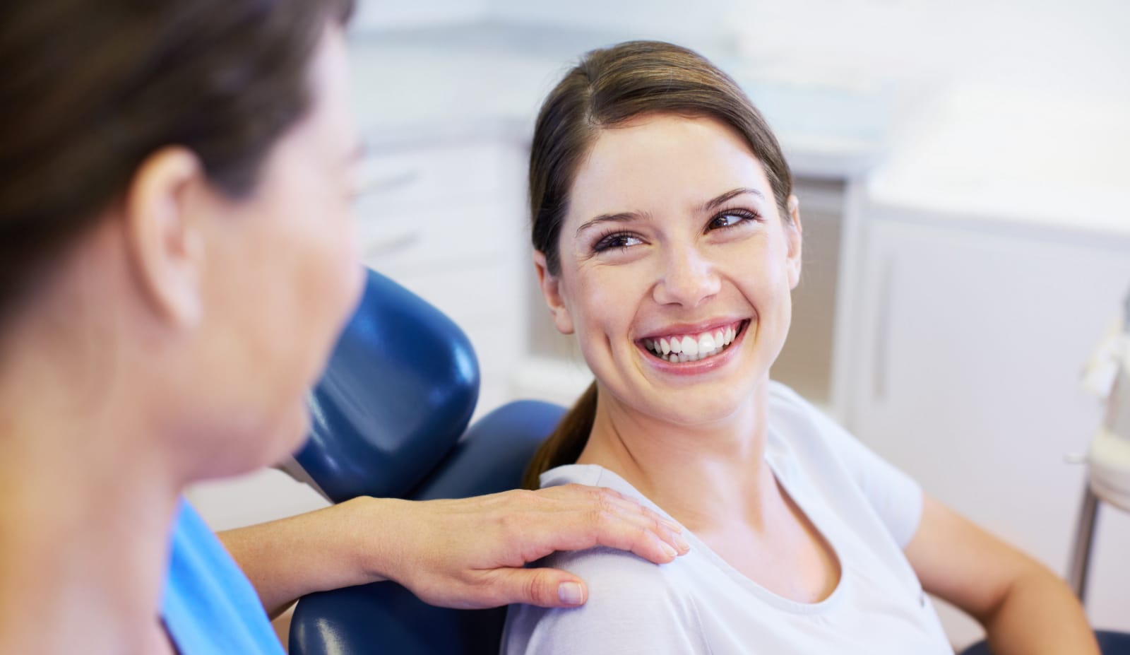 lady smiling in dentist chair photo